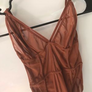 Brand new copper body suit never worn. Sheer mesh.